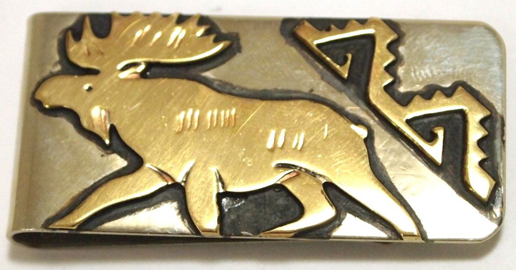 Navajo 12k Gold Fill over Sterling Silver Moose Money C: Navajo 12k Gold Fill over Sterling Silver Moose Money Clip - Tommy Singer Measures 2 tall by 1" wide.Note: Money clips are nickel or stainless steel as purchased by the artist. The work on top of the
