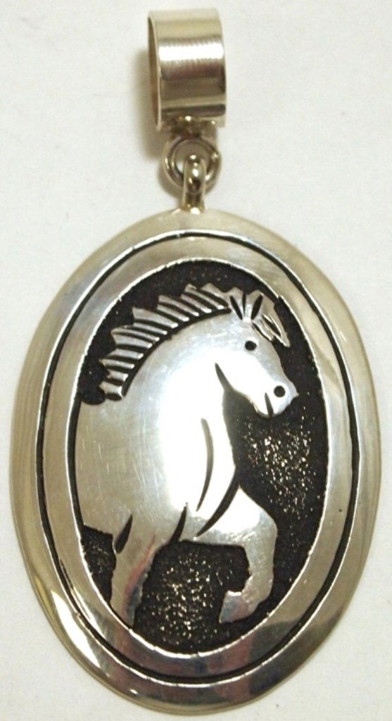 Navajo Sterling Silver Horse Pendant - Tommy Singer: Navajo Sterling Silver Horse Pendant - Tommy Singer Measures 2-1/2 tall by 1-1/4" wide including bale. Bale opening measures 3/8". Weight: 11.5g SKU: pp0987"