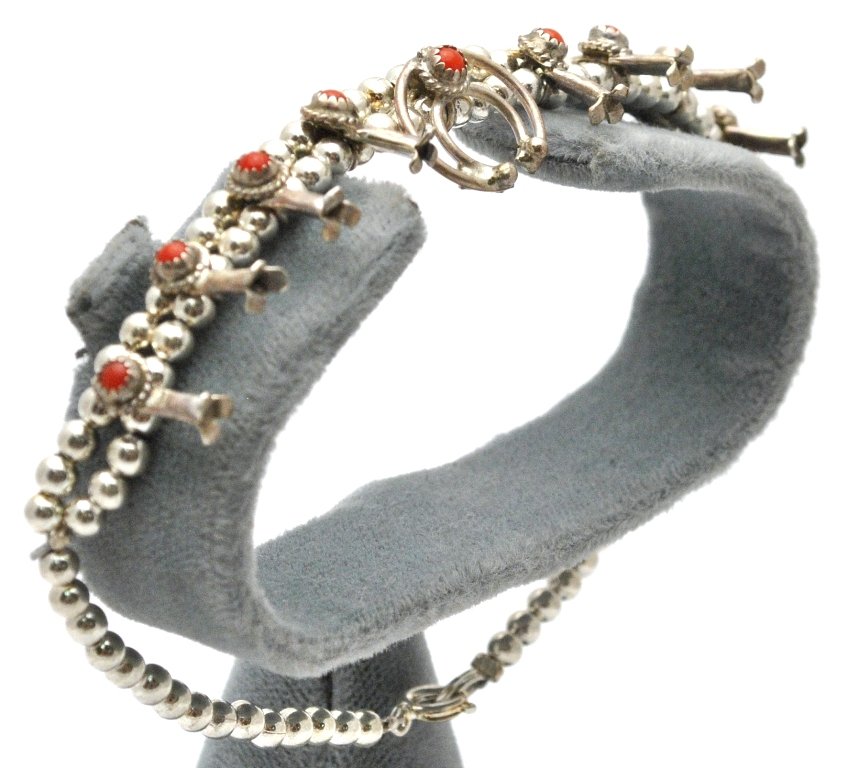 Navajo Coral Sterling Silver Squash Blossom Bracelet - : Navajo Coral Sterling Silver Squash Blossom Bracelet - Larry Curley Measures 8 long. Blossoms measure 3/8" tall by 1/8" wide. Naja measures 1/2" tall by 9/16" wide. Weight: 11.1g SKU: br0332"