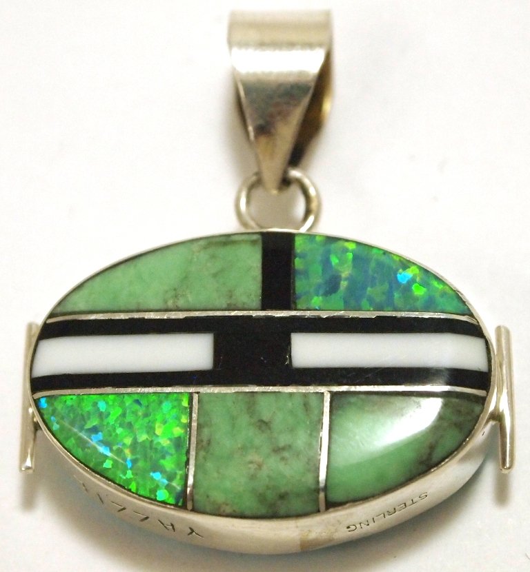 Navajo Multi-Stone Reversible Inlay Sterling Silver Pen: Navajo Multi-Stone Reversible Inlay Sterling Silver Pendant - Edison Yazzie Measures 1-3/8 tall by 1-1/8" wide including bale. Bale opening measures 1/4". Stones present: Tuquoise, Green Turquoise, Op