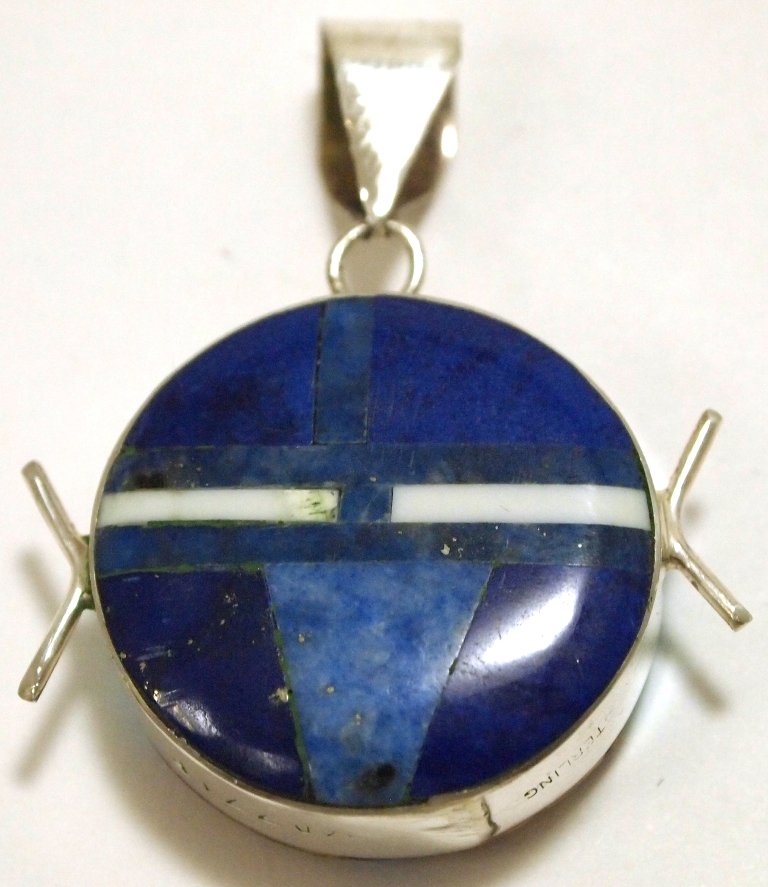 Navajo Multi-Stone Reversible Inlay Sterling Silver Pen: Navajo Multi-Stone Reversible Inlay Sterling Silver Pendant - Edison Yazzie Measures 1-1/2 tall by 1-1/8" wide including bale. Bale opening measures 1/4". Stones present: Tuquoise, Lapis Lazuli, Denim