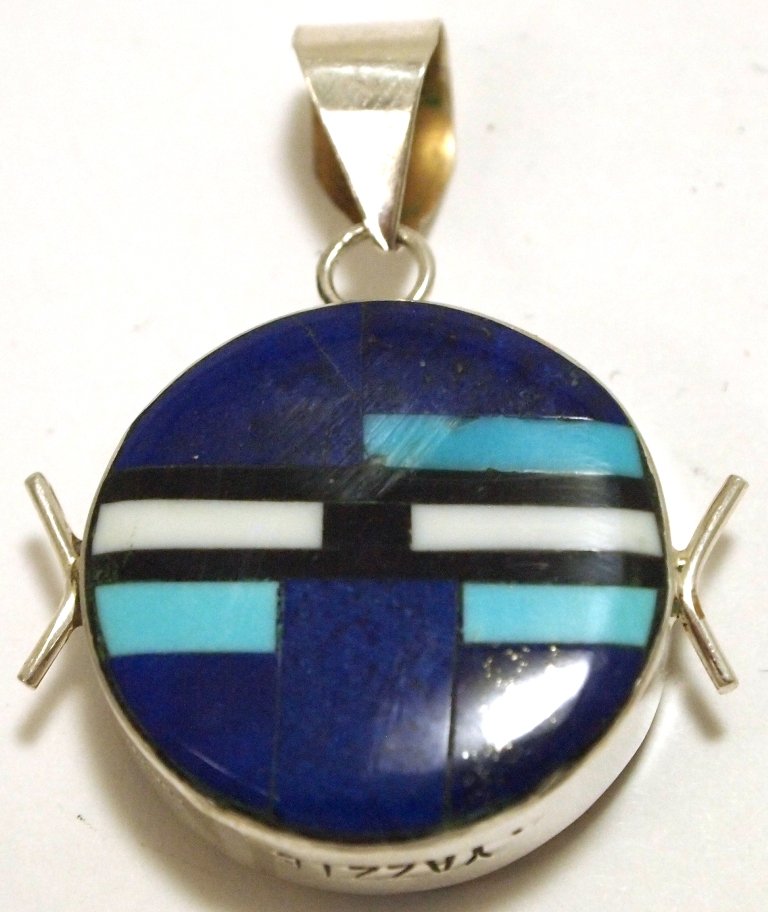 Navajo Multi-Stone Reversible Inlay Sterling Silver Pen: Navajo Multi-Stone Reversible Inlay Sterling Silver Pendant - Edison Yazzie Measures 1-1/2 tall by 1-1/8" wide including bale. Bale opening measures 1/4". Stones present: Tuquoise, Lapis Lazuli, Jaspe