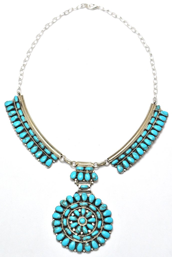 Navajo Turquoise Cluster Necklace - Juliana Williams: Navajo Turquoise Cluster Necklace - Juliana Williams Measures 17 around. Pendant measures 2" in diameter. Side strips measure 3" long by 3/4" wide. Middle connector measures 1-1/8" tall by 1" wide. We