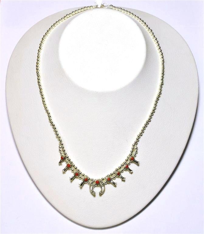 Navajo Coral Sterling Silver Mini Squash Blossom Neckla: Navajo Coral Sterling Silver Mini Squash Blossom Necklace - Larry Curley Measures 17" around. Naja measures 1/2" tall by 1/2" wide. Weight: 13.4g SKU: