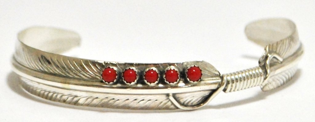 Navajo Coral Dots Sterling Silver Feather Bracelet - Ch: Navajo Coral Dots Sterling Silver Feather Bracelet - Chris Charley Measures 5-1/8 around with a 1-1/4" gap, 3/8" wide. Chris' pieces are exceedingly affordable; because of this the silver is thin and 