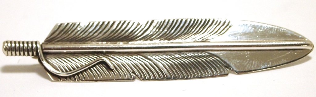 Navajo Sterling Silver Feather Pin - Chris Charley: Navajo Sterling Silver Feather Pin - Chris Charley Measures 1/2 tall by 2-1/2" wide. Pin on back measures 1-3/4". Weight: 5.1g SKU: pp0974"