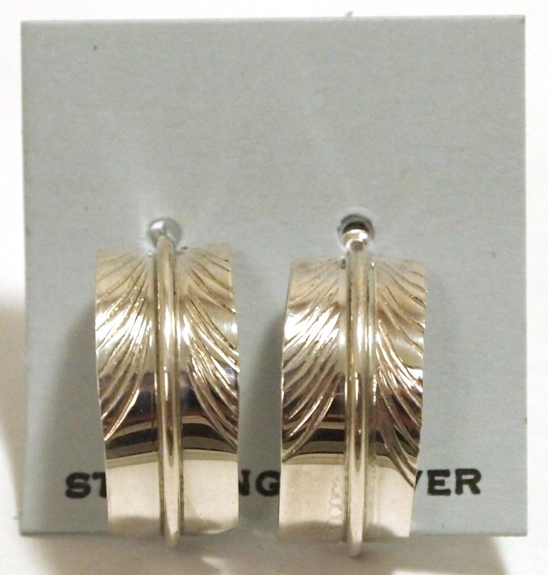 Navajo Sterling Silver Feather Post Earrings - Chris Ch: Navajo Sterling Silver Feather Post Earrings - Chris Charley Measure 5/8 tall by 1/4" wide. Chris' pieces are exceedingly affordable; because of this the silver is thin and flexible and may have sligh