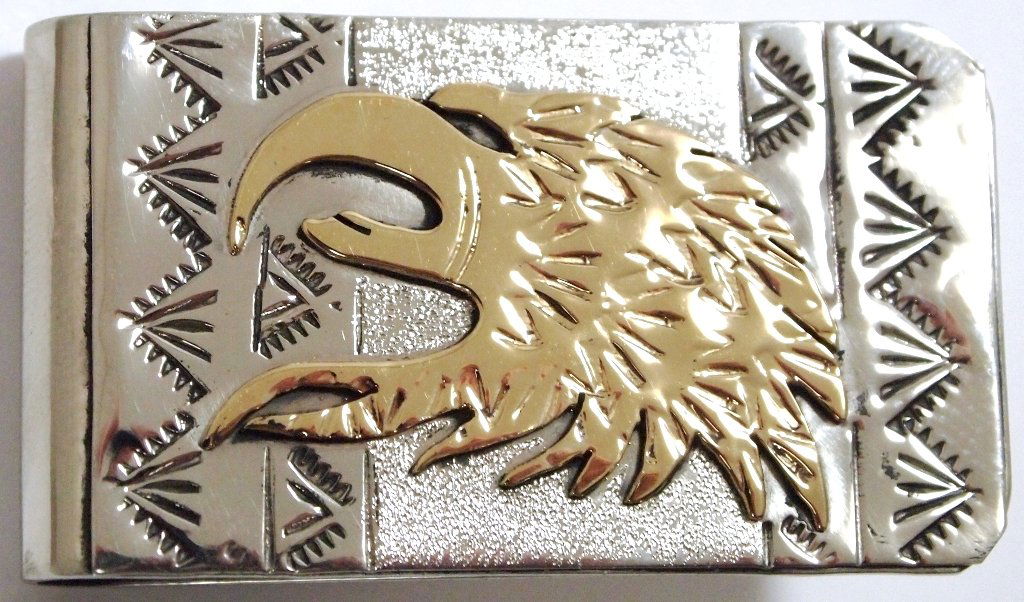 Navajo 12k Gold Fill over Sterling Silver Eagle Head: Navajo 12k Gold Fill over Sterling Silver Eagle Head Money Clip - Roger Jones Measures 1-3/4 tall by 1" wide.Note: Money clips are nickel or stainless steel as purchased by the artist. The work on top