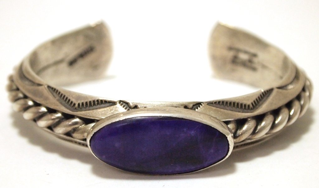 Vintage Old Pawn Navajo Sugilite Sterling Silver Cuff: Vintage Old Pawn Navajo Sugilite Sterling Silver Cuff Bracelet - Orville Tsinnie Measures 5-5/8 around with a 1" gap, 1/2" wide. Weight: 74.2g SKU: br1947"