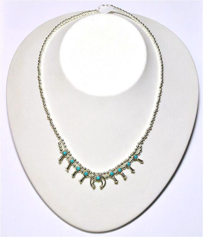 Navajo Turquoise Sterling Silver Mini Squash Blossom: Navajo Turquoise Sterling Silver Mini Squash Blossom Necklace - Larry Curley Measures 17 around. Naja measures 1/2" tall by 1/2" wide. Weight: 13.6g SKU: ne0011"