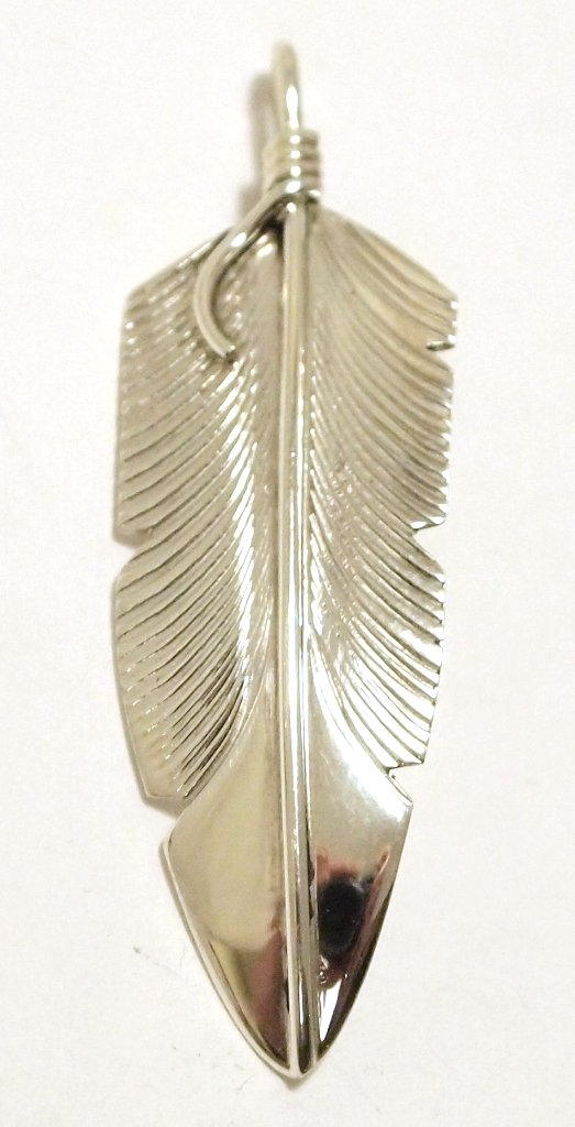 Navajo Sterling Silver Feather Pendant - Chris Charley: Navajo Sterling Silver Feather Pendant - Chris Charley Measures 1-3/4 tall by 1/2" wide including bale. Bale opening measures 1/8". Weight: 3g SKU: pp1147"