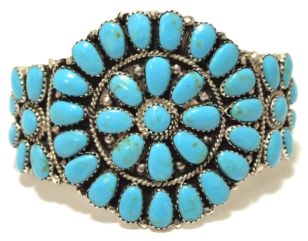 Navajo Turquoise Cluster Sterling Silver Cuff Bracelet: Navajo Turquoise Cluster Sterling Silver Cuff Bracelet - Juliana Williams Measures 5-1/4 around with a 1-1/4" gap, 2" wide. Turquoise matrix may vary. Weight: 30.1g SKU: br1089"