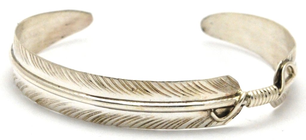 Navajo Sterling Silver Feather Bracelet - Chris Charley: Navajo Sterling Silver Feather Bracelet - Chris Charley Measures 5 around with a 7/8" gap, 3/8" wide. Chris' pieces are exceedingly affordable; because of this the silver is thin and flexible and may 