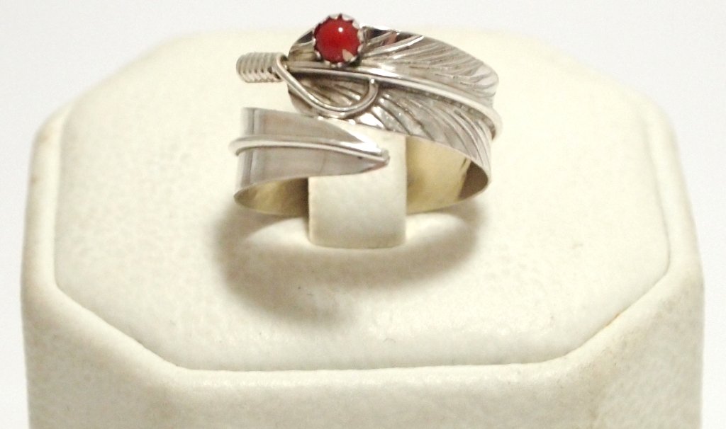 Navajo Coral Sterling Silver Feather Adjustable Women's: Navajo Coral Sterling Silver Feather Adjustable Women's Ring - Chris Charley Measures 1/4 wide. Ring is flexible, default size 6.5 to 7. When bending ring, size ranges from 4 to 11 (ring separates bey