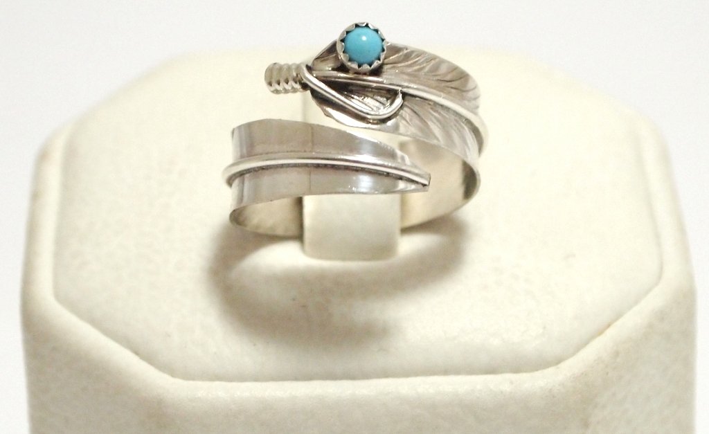 Navajo Turquoise Sterling Silver Feather Adjustable: Navajo Turquoise Sterling Silver Feather Adjustable Women's Ring - Chris Charley Measures 1/4 wide. Ring is flexible, default size 6.5 to 7. When bending ring, size ranges from 4 to 11 (ring separates