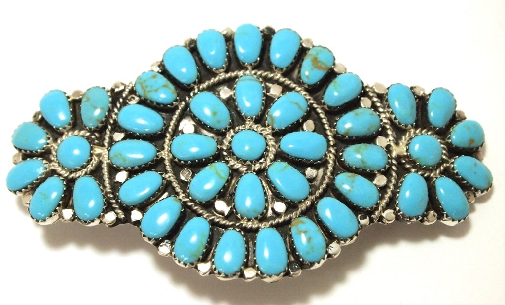 Navajo Turquoise Cluster Sterling Silver Hair Barrette: Navajo Turquoise Cluster Sterling Silver Hair Barrette - Juliana Williams Measures 2 tall by 3-1/2" wide. Barrette on back measures 2" long. Turquoise matrix may vary. Weight: 23.1g SKU: hb0019"