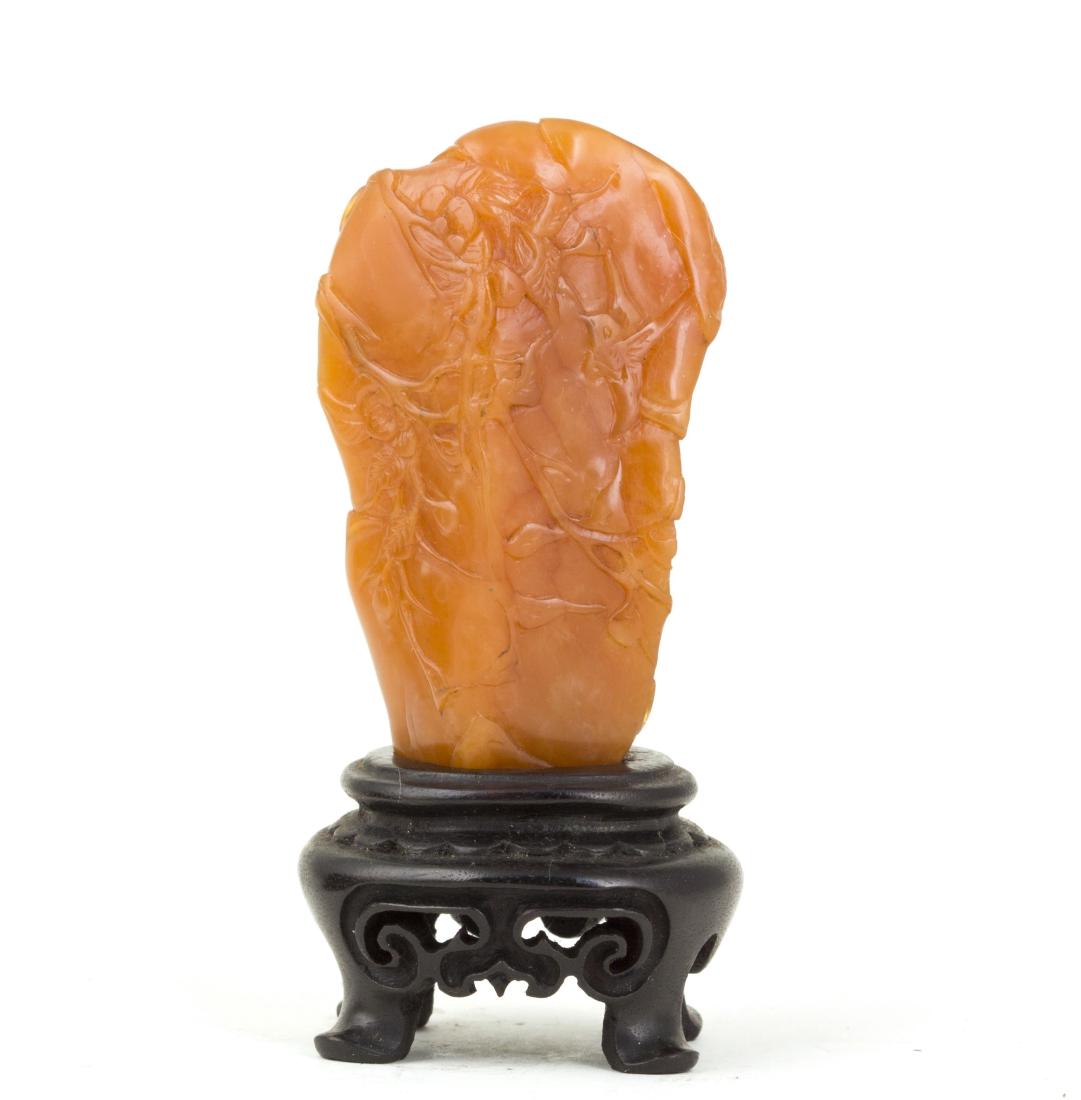 A SOAPSTONE ORNAMENT WITH WOODEN BASE: Tian Huang Color Soapstone Ornament with finely carved and high polished. The pattern describe flower and birds. This item includes wood base. Length 1" Width 0.75" Height 2.5"