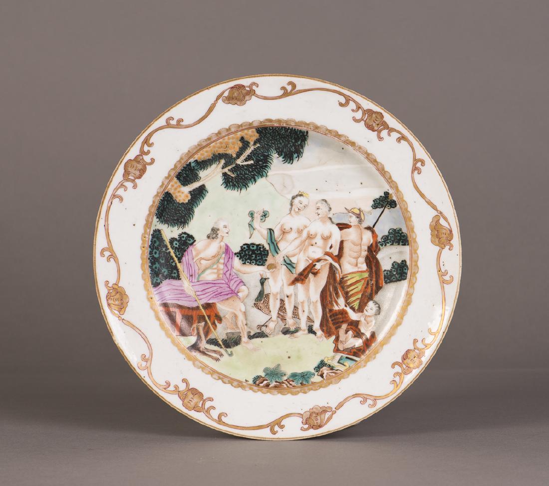 A WESTERN PORCELAIN PLATE: A porcelain plate enameled with shirtless young guys and a baby boy on the grassy ground, a band of floral patterns on the rim. Height 1" Diameter 9"