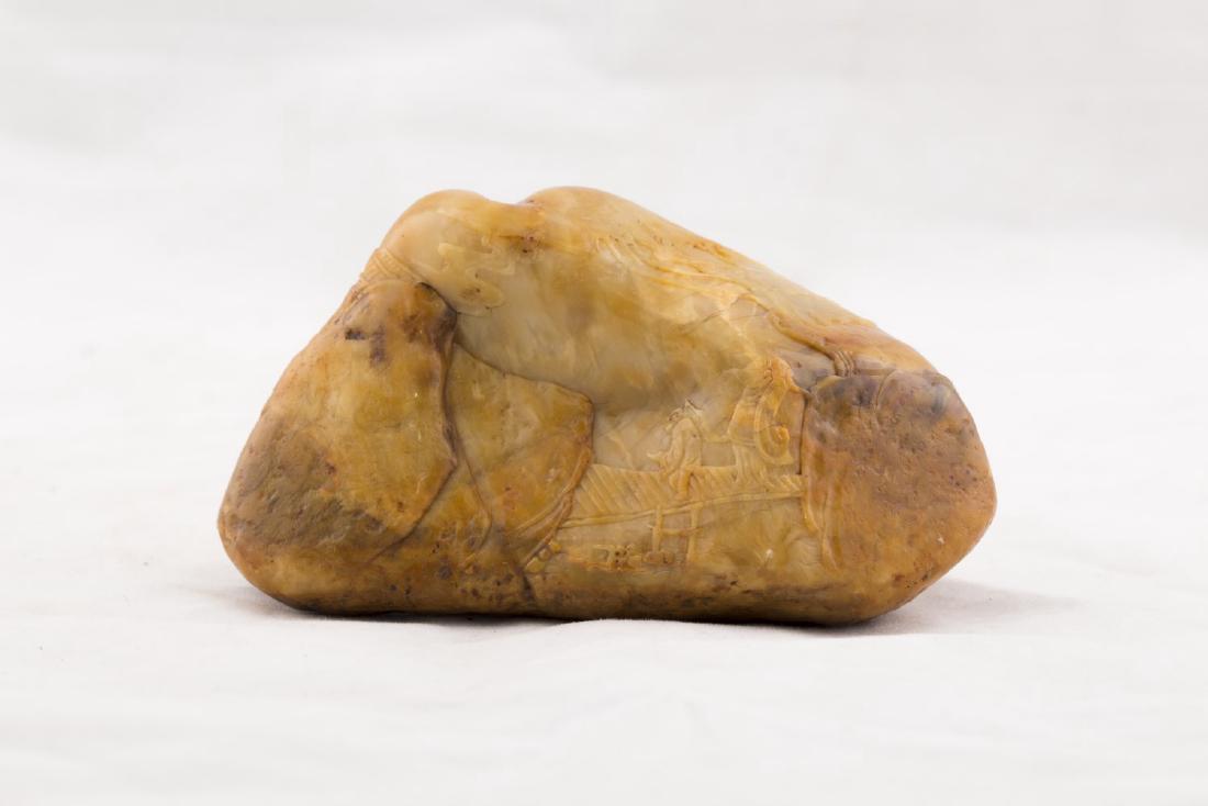 A NATURE FORM SOAPSTONE TOGGLE: A nature form soapstone toggle with carved landscape mountain motif. Height 2.25'' Length 4.5'' Width 2.25''