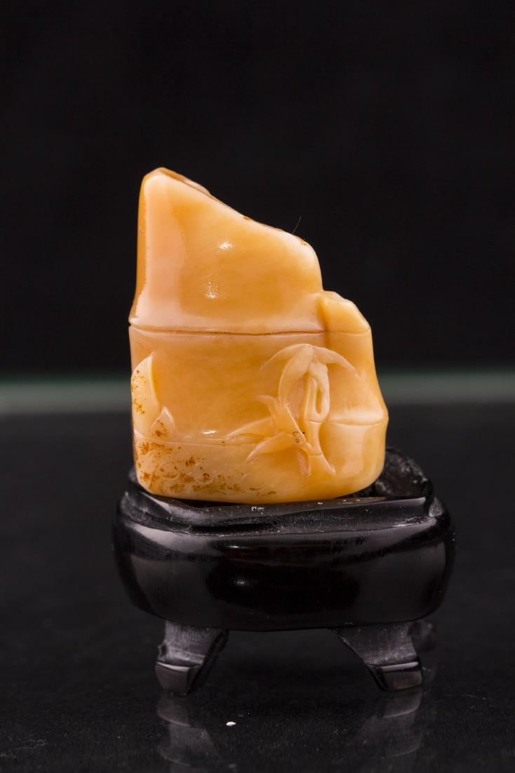 TIANHUANG SOAPSTONE ORNAMENT WITH 4-FOOT HARDWOOD BASE: A Fine TianHuang Soapstone Ornament with Bamboo Shoots relief, set on a 4-foot Hardwood Base. Length 1'' Width 0.5'' Height 1.25''