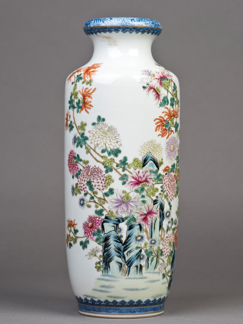 A DOUCAI ROULEAU PORCELAIN VASE: A doucai Rouleau porcelain vase, featuring floral motif paintings, supported on a cylindrical body with a think flared mouth, a six-character seal imprinted on the base. Height 13.25" Diameter 5.5"