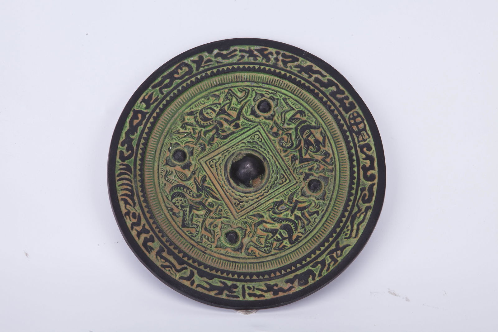 A CHINESE BRONZE MIRROR (1 of 2)