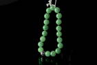 A STRING OF JADEITE BEADS BRACELET