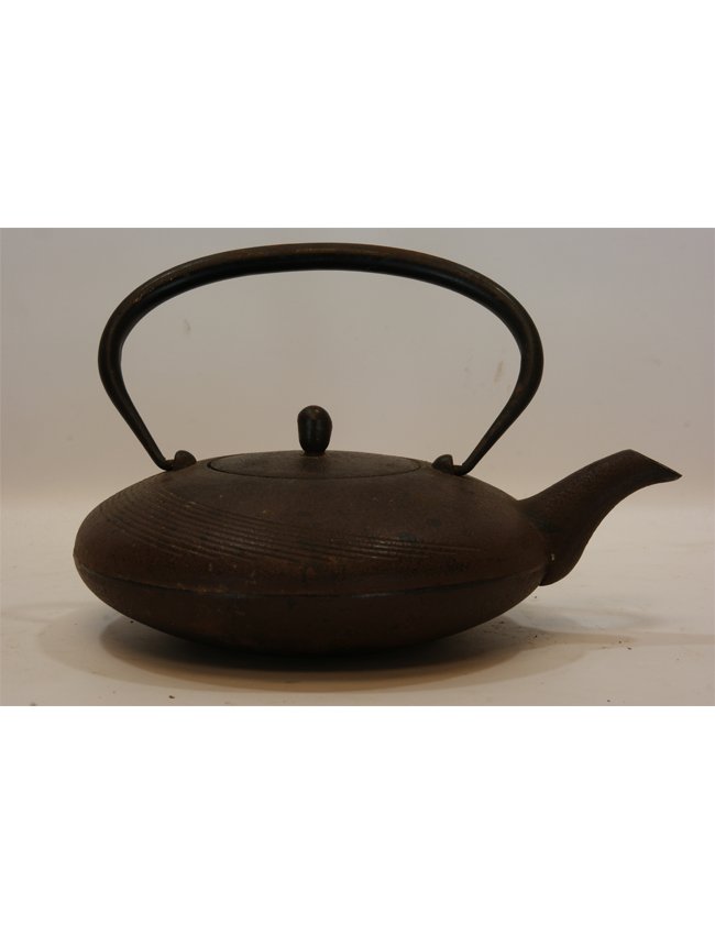 Japanese Cast Iron Teapot: Japanese Iron cast teapot with corrugated siding, an oversized loop handle and artichoke detail lid. Length 10" Height 7"