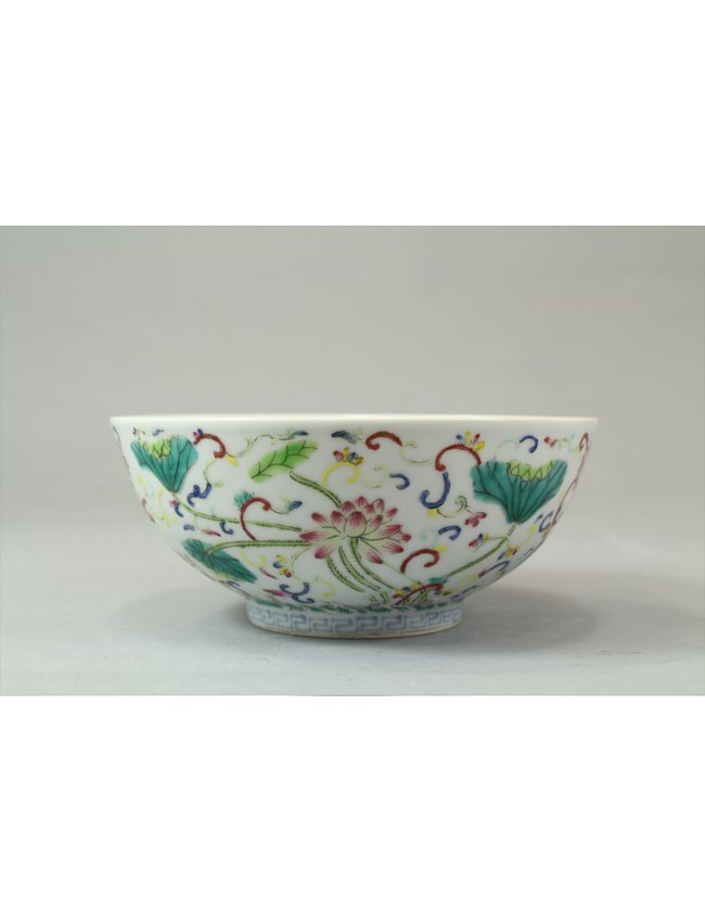 Chinese Famille Rose Bowl: Vividly painted Famille Rose bowl with lotus blossom and springtime flower sprays and key frette markings on the base. 19th Century. Length 6" Height 2.5"