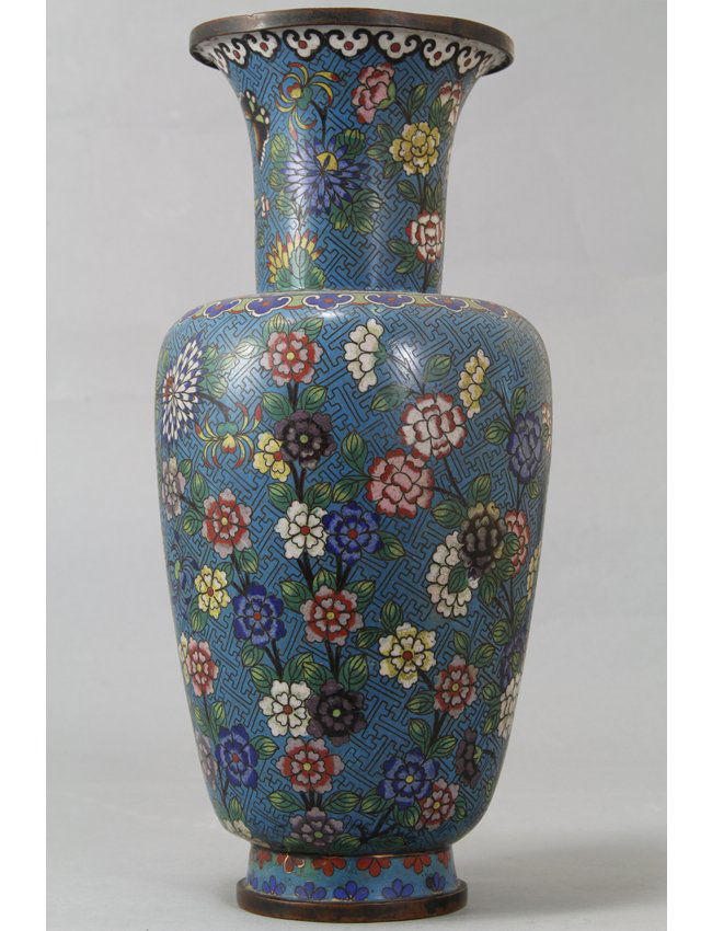 Cloisonne Vase: Baluster form cloisonne vase with blooming lotus and prunus with leaf detail on a blue background supported on a slightly flared base. Length 7" Height 14.5"