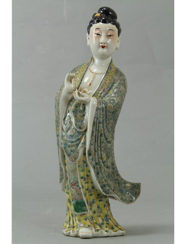 Porcelain Famille Rose goddess sculpture: Porcelain Famille Rose goddess sculpture in flowing gowns with blossom details in pale blue and yellow. The goddess has blushed cheeks, red lips and a serene countenance. Late 20th century. Length 5"