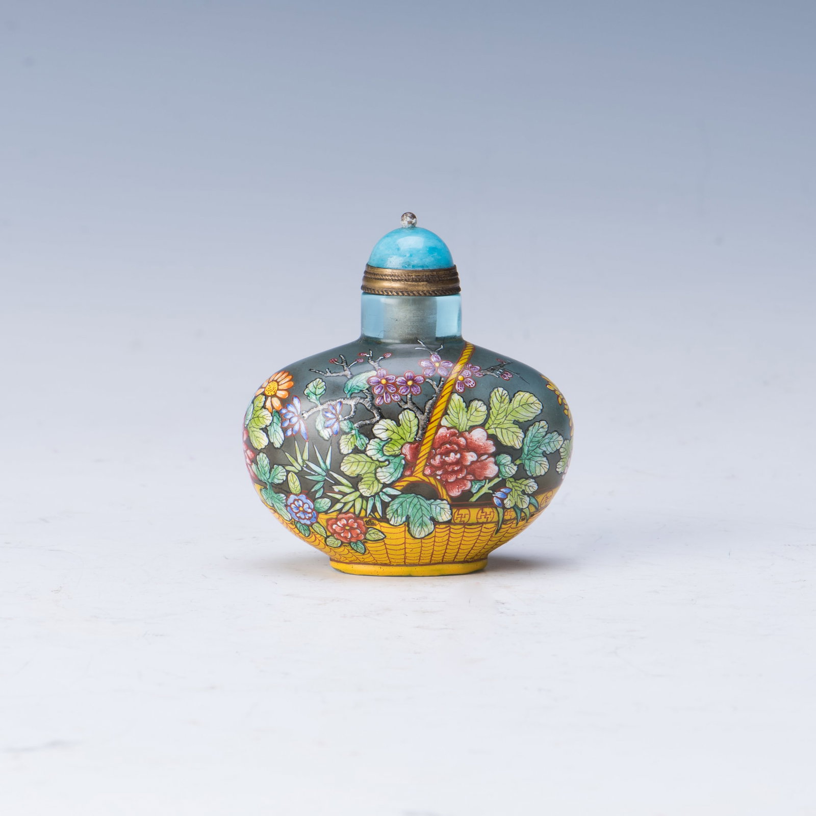 CHINESE PEKING GLASS SNUFF BOTTLE: A compressed Chinese Peking Glass Snuff Bottle, enameled with flower blossoms and a Chinese Painting. Height 2.5” Width 2.25“