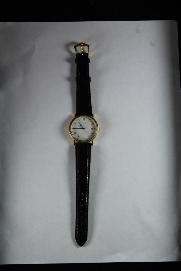 Patek Philippe Wrist Watch 18K Gold , leather strap. Co: Patek Philippe Leather strap Wristwatch, movement no. 1.556.021. Calibre: E 23 SC; date, sweep second hand; quartz. Case No. 2.919.017. Porcelain-white, black roman hour markers. Manufactured in year