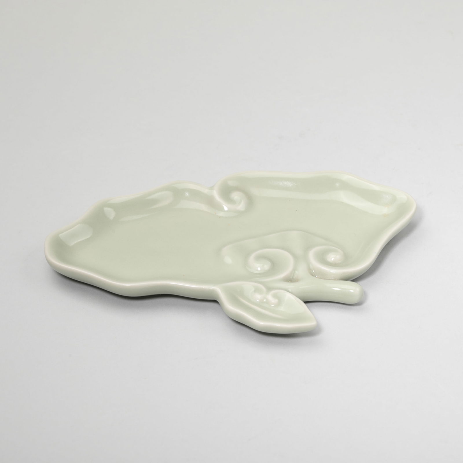 CELADON GLAZE RUYI-SHAPE BRUSH WASHER: Celadon glaze ruyi-shape brush washer. Length: 16.8 cm.