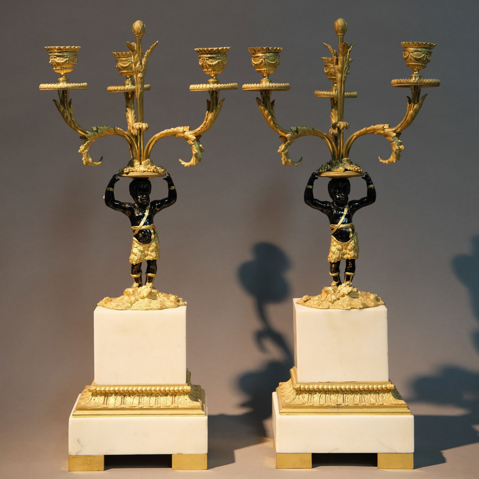 PAIR OF GILT DECORATED FIGURE CANDLESTICKS: Pair of gilt decorated figure candlesticks. Height: 50.5 cm.