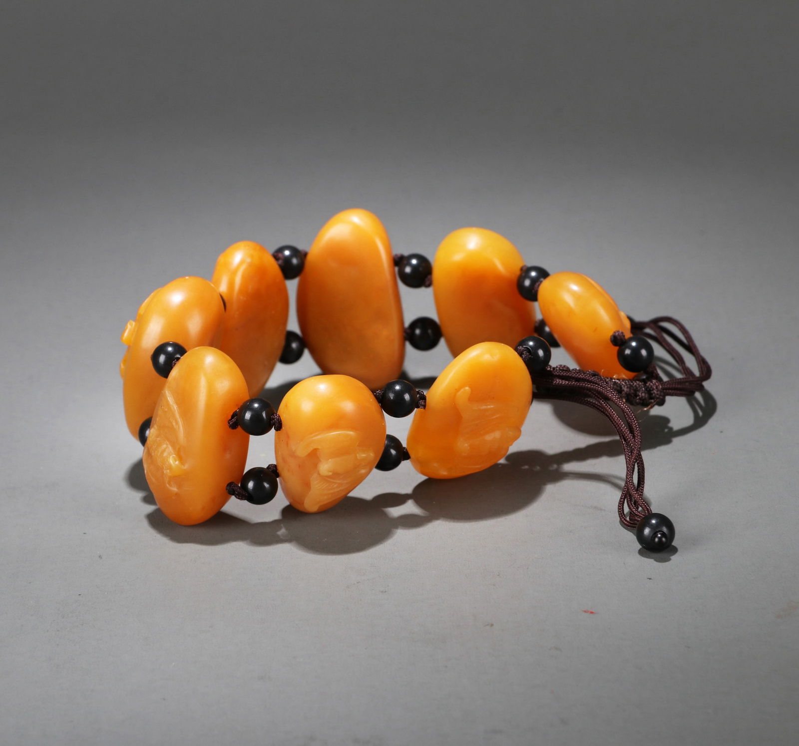 A TIANHUANG STONE BRACELET: A Tianhuang stone bracelet carved with 'Fu Zai Yan Qian' design. Length 2.5 cm.