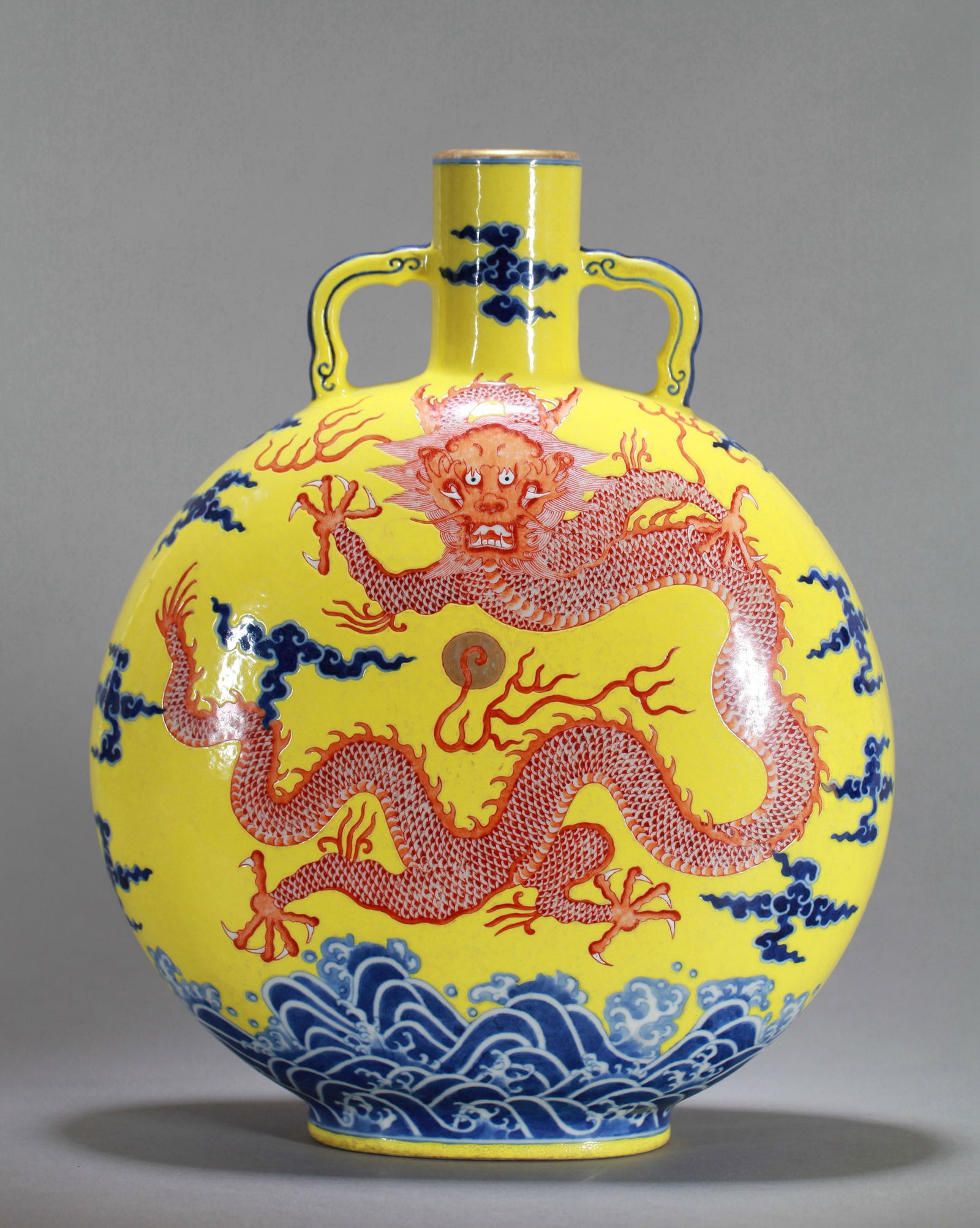 A YELLOW-GROUND BLUE AND WHITE IRON-RED FLASK: A yellow-ground blue and white moon flask decorated with iron-red dragon design. Height 32 cm.