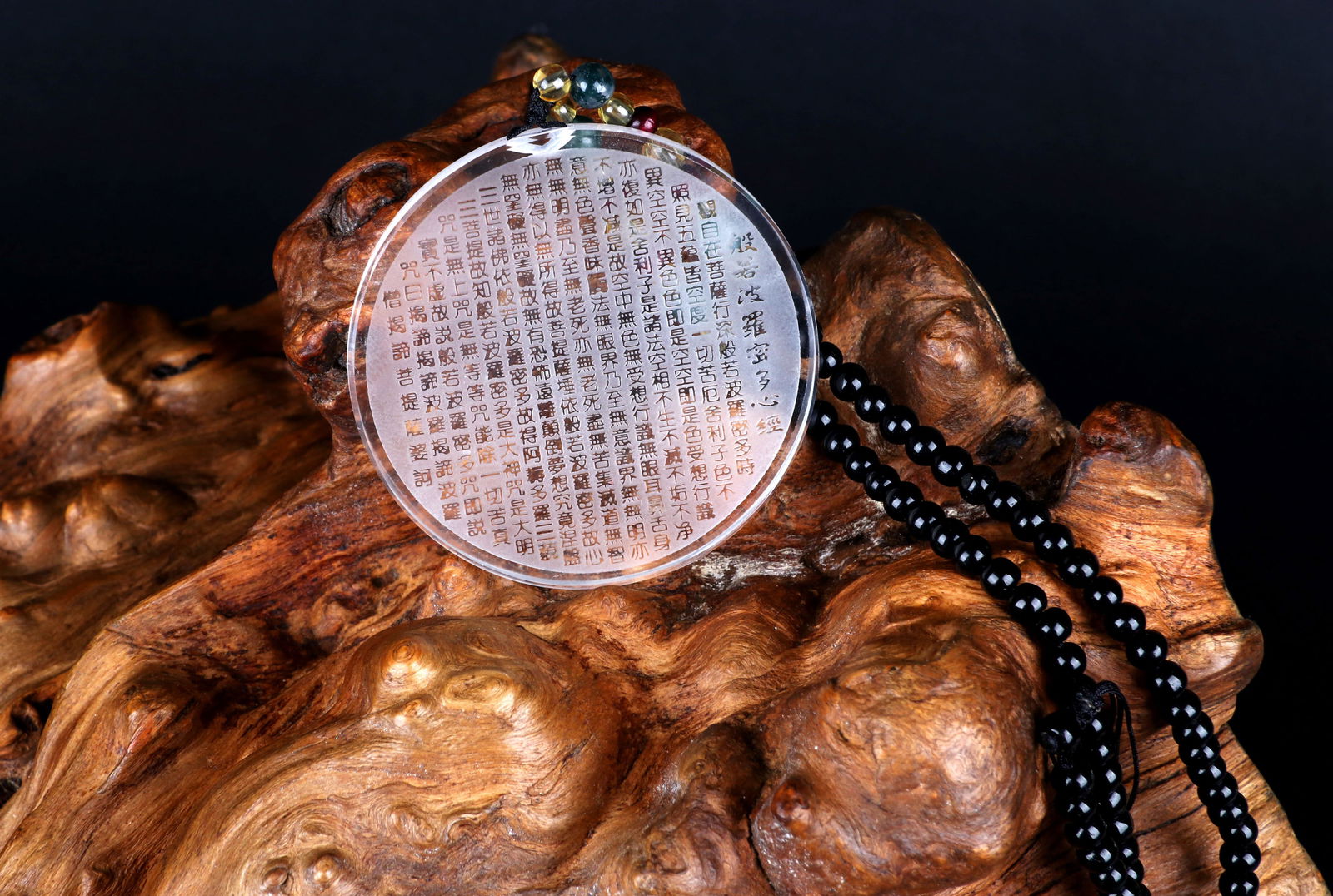 A CARVED CRYSTAL PLAQUE: A crystal plaque finely carved with Heart Sutra. Diameter 5.5 cm.