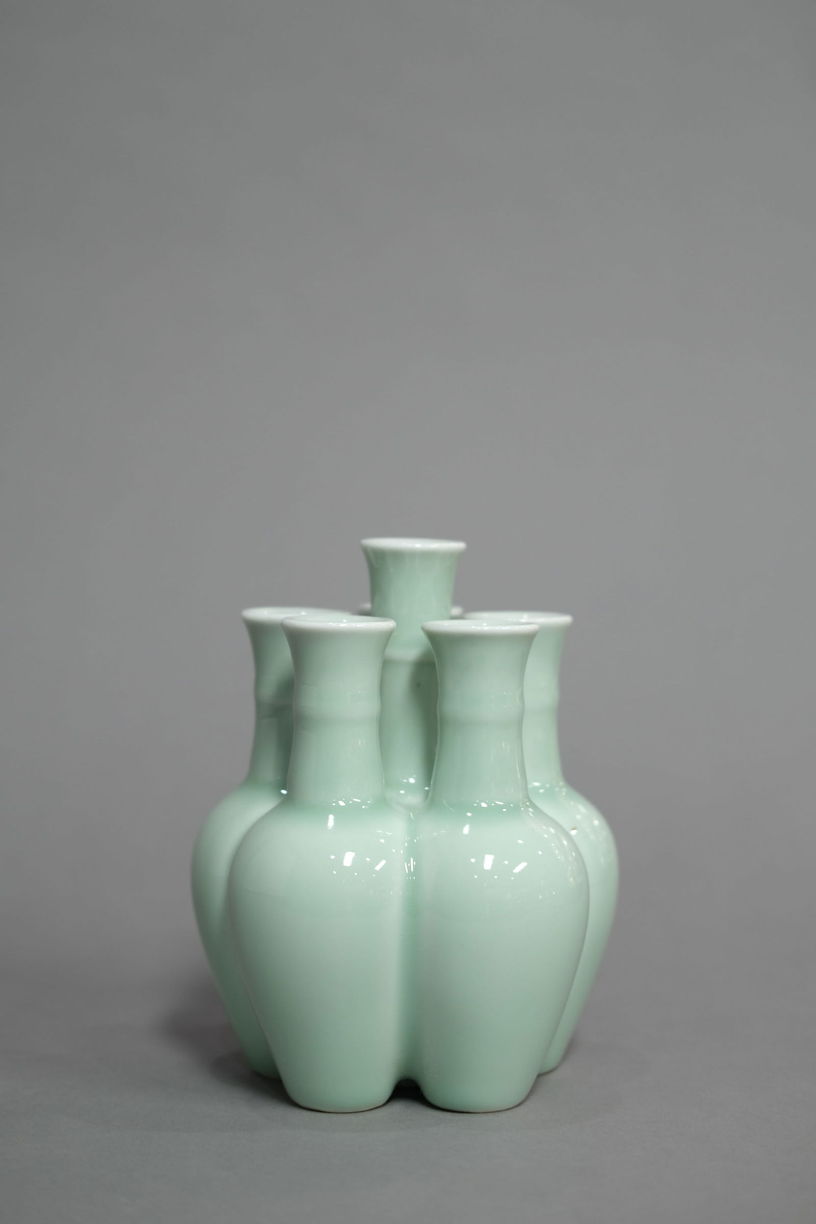 CELADON GLAZE FIVE-SPOUTS VASE: Celadon glaze five-spouts vase.Dimensions: Height: 17.5 cm.