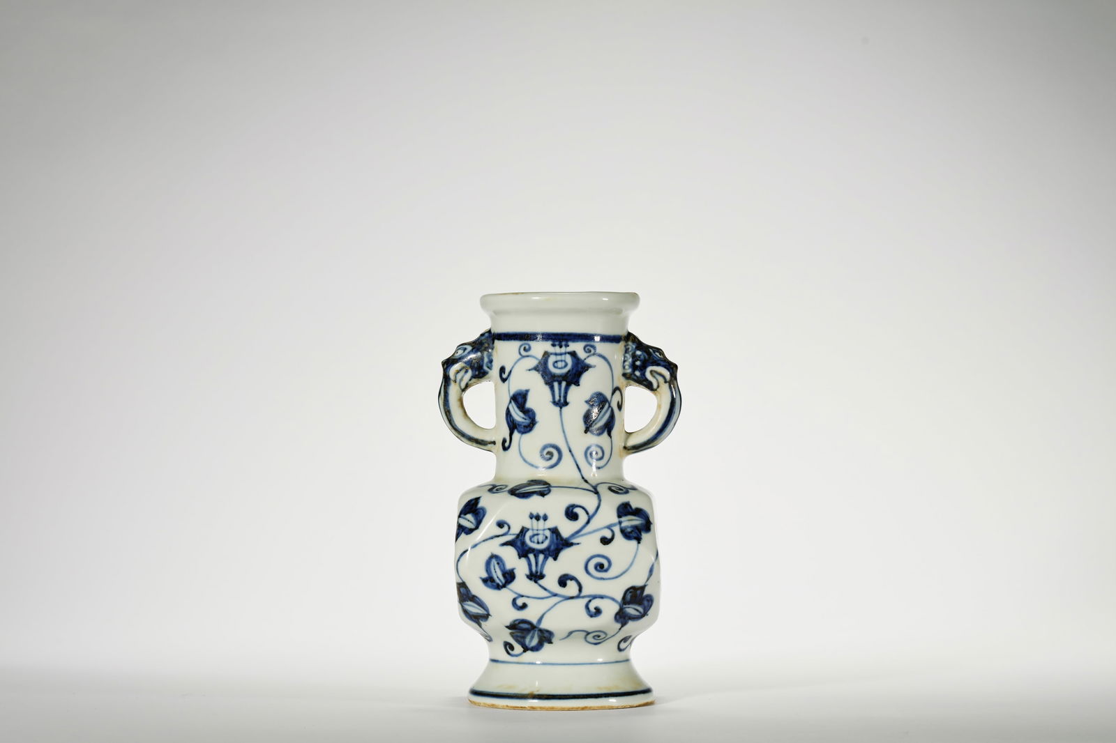 BLUE AND WHITE BEAST-EARED FACETED ZUN: Blue and white beast-eared faceted zun. Dimensions: Height: 18.3 cm, Width: 10 cm.