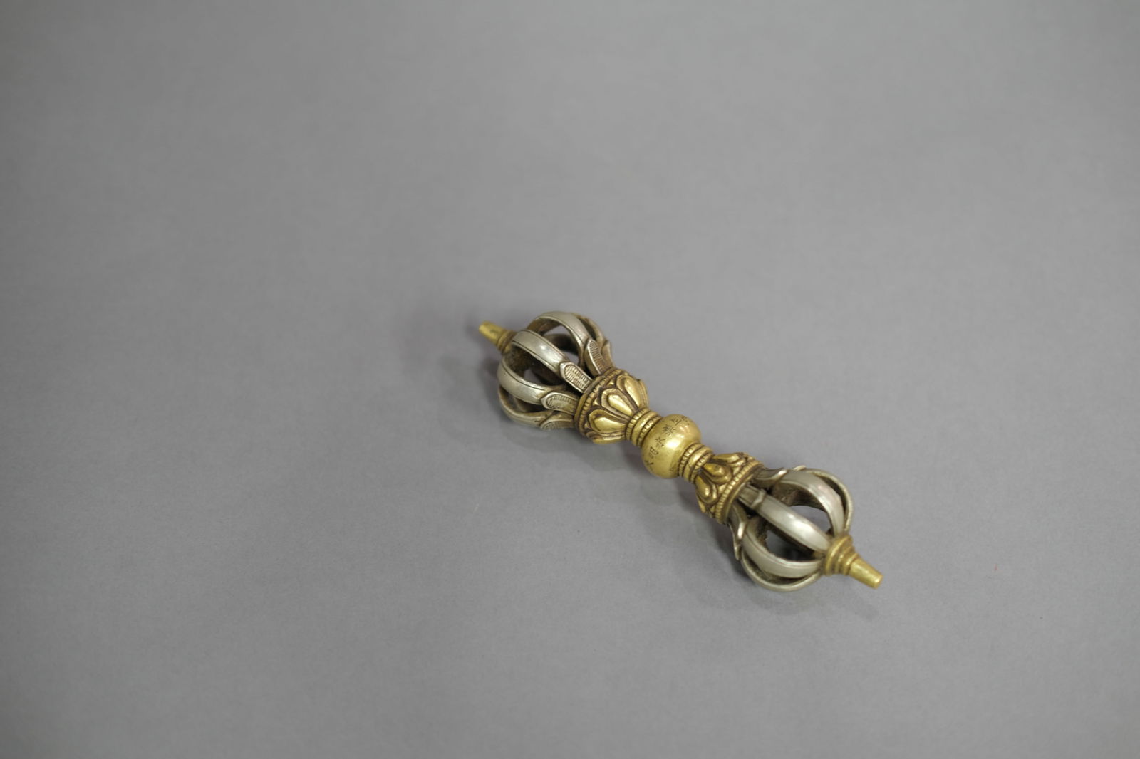 GOLD AND SILVER INLAYING BRONZE VAJRA: Gold and silver inlaying bronze vajra. Dimensions: Length: 15 cm.