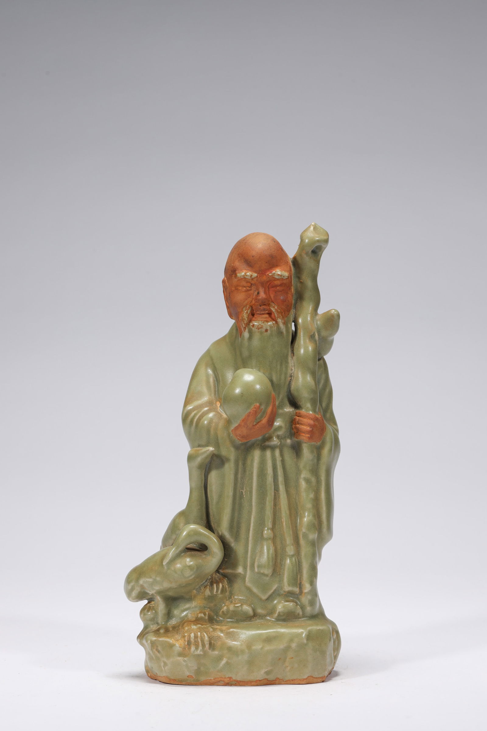 LONGQUAN KILN IMMORTAL STATUE: Longquan kiln immortal statue. Dimensions: Height: 14.8 cm, Width: 11.5 cm.