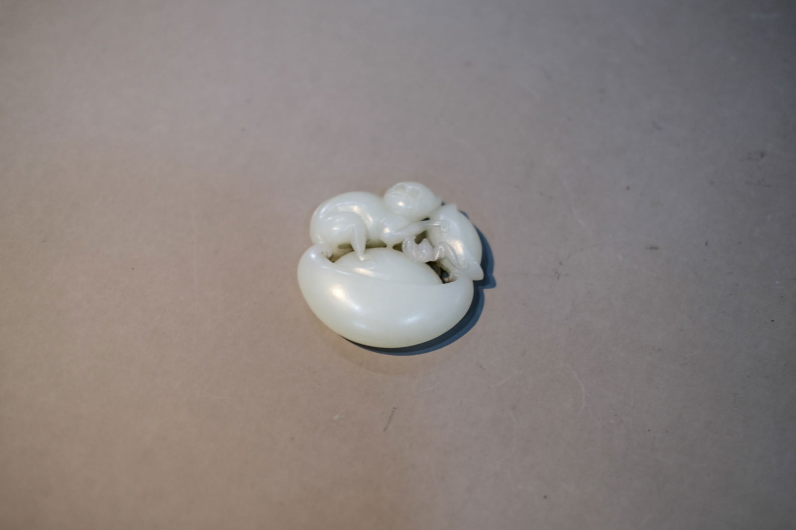 WHITE JADE MONKEY AND INGOT ORNAMENT: White jade monkey and ingot ornament. Dimensions: Diameter: 5 cm.
