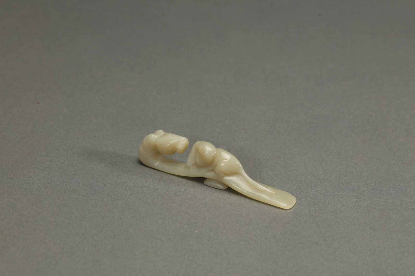 WHITE JADE DRAGON BELT HOOK: White jade dragon belt hook. Dimensions: Length: 9.9 cm, Width: 1.5 cm.