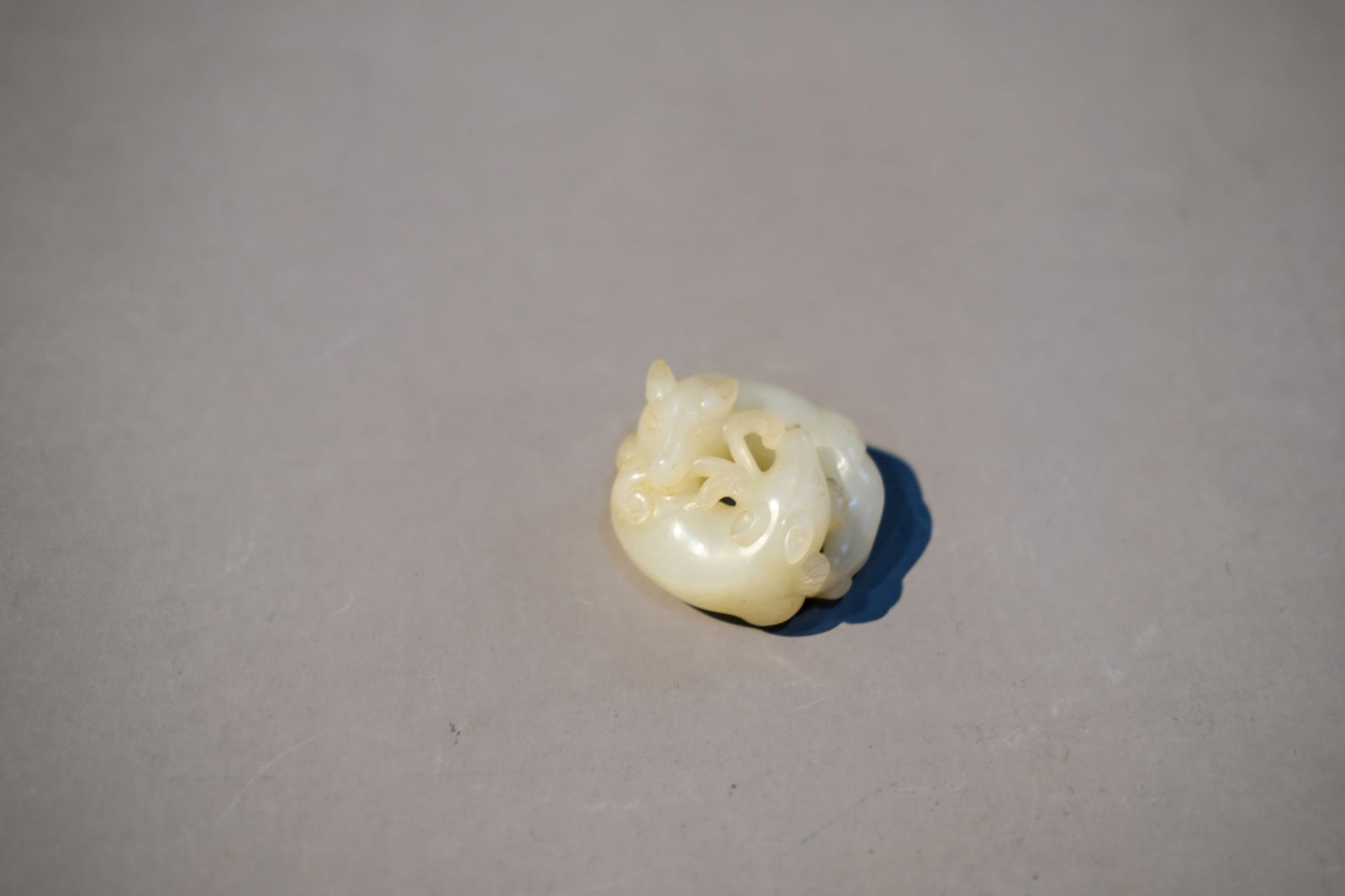 WHITE JADE STAG AND LINGZHI ORNAMENT: White jade Stag and Lingzhi ornament. Dimensions: Length: 4.7 cm, Height: 2.8 cm.