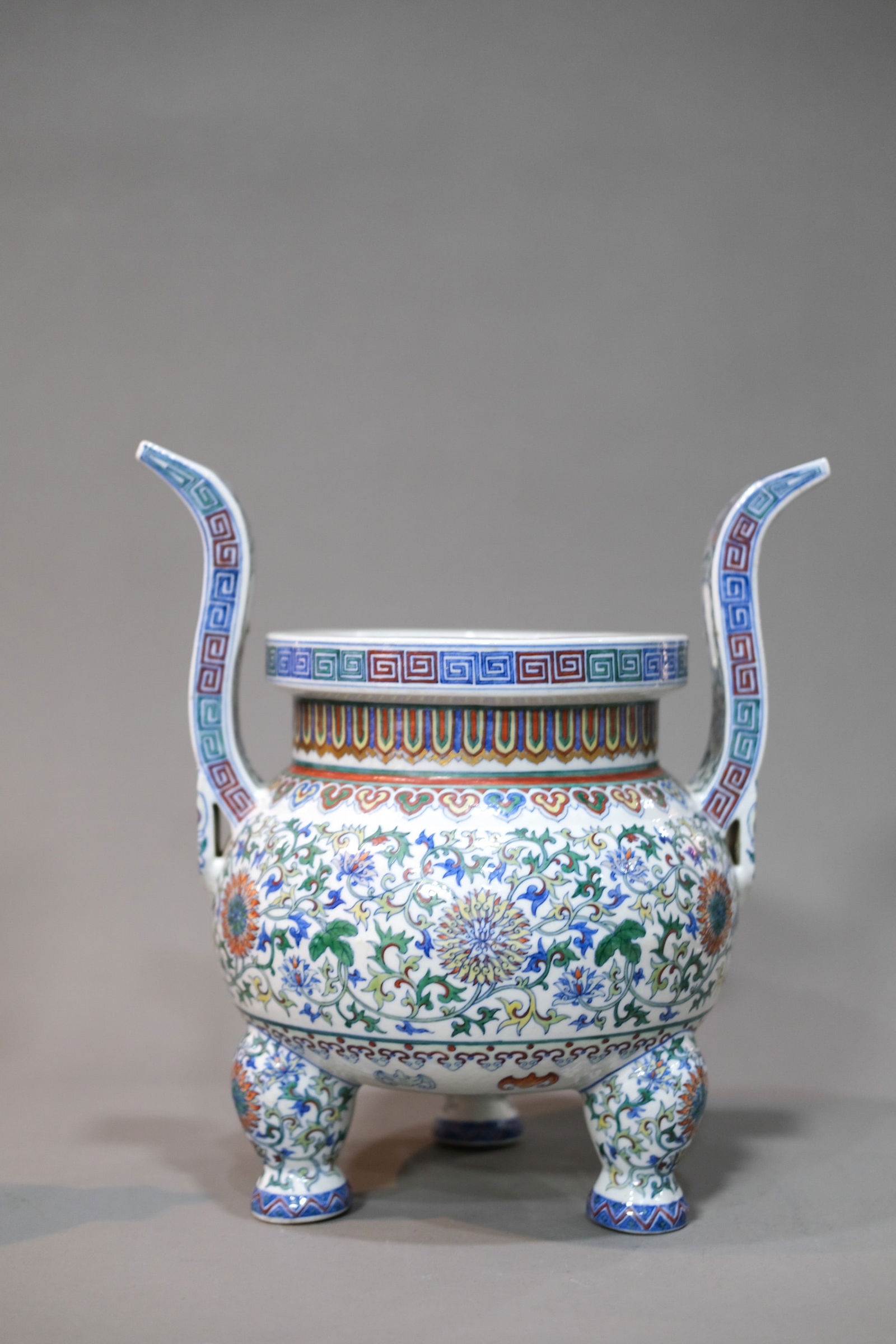 DOUCAI GLAZE INTERLOCKING LOTUS TRIPOD INCENSE BURNER: Doucai glaze interlocking lotus tripod incense burner. Dimensions: Height: 30.5 cm.