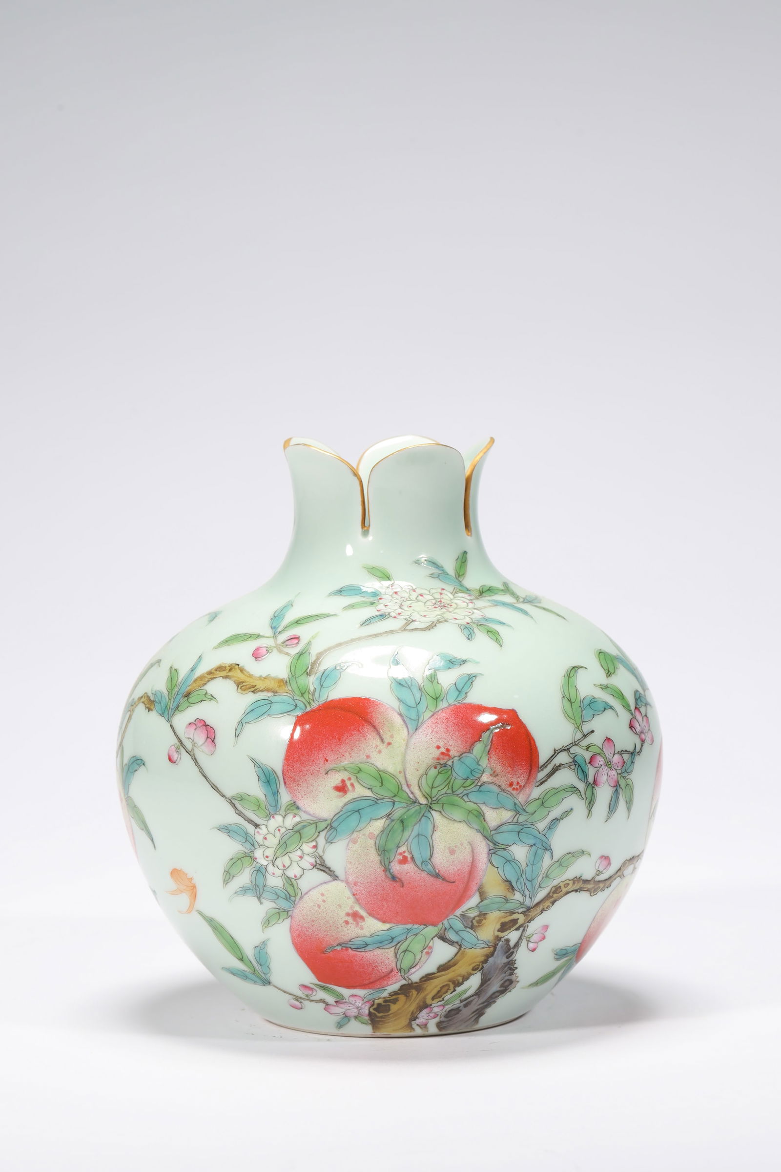 CELADON GLAZE FAMILLE ROSE POMEGRANATE ZUN: Celadon glaze famille rose pomegranate zun. Dimensions: Height: 16 cm, Bottom Diameter: 7.2 cm.