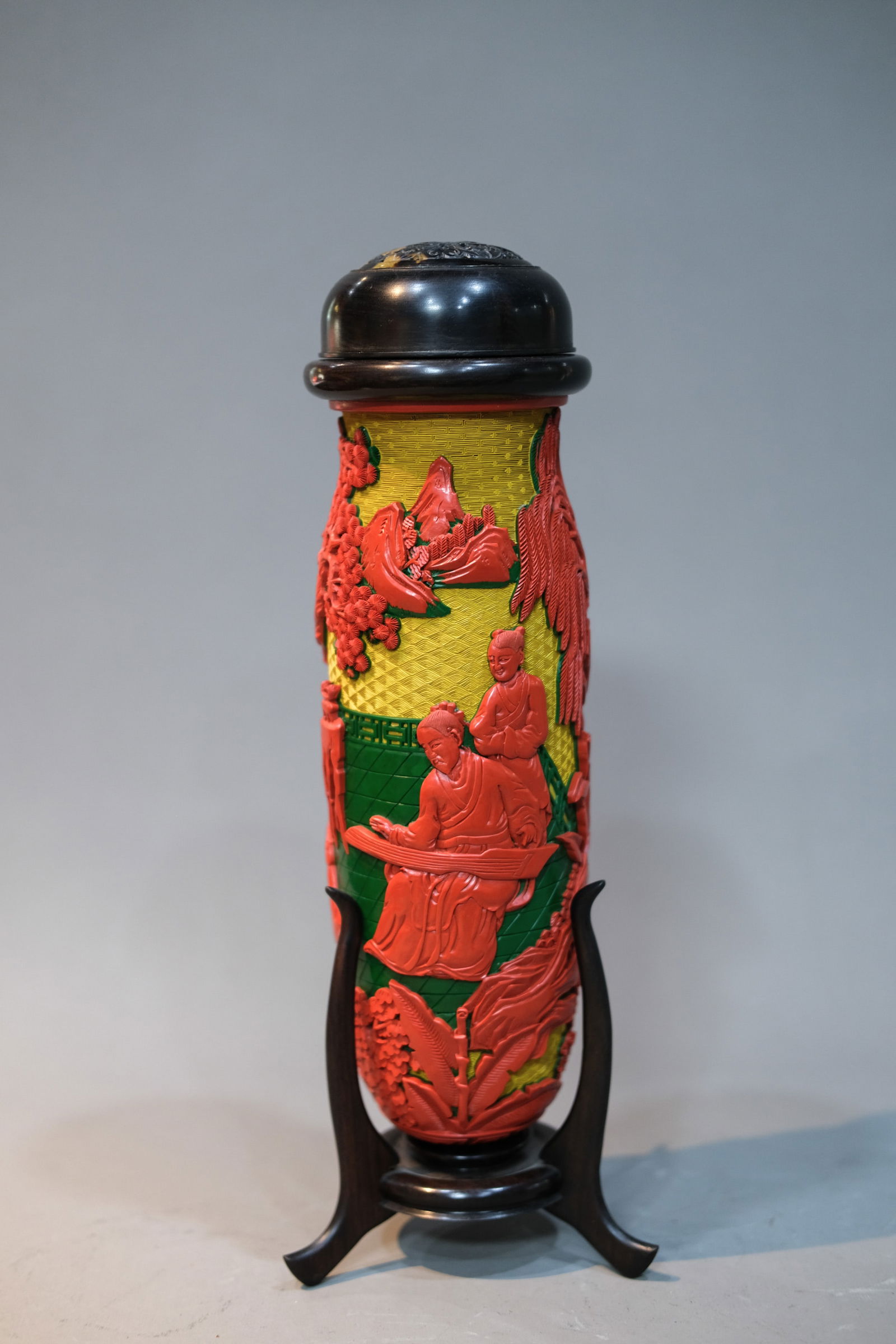 CARVED YELLOW, GREEN AND CINNABAR LACQUER FIGURE STORY CRICKET JAR: Carved yellow, green and cinnabar lacquer figure story cricket jar. Dimensions: Height: 30.5 cm.