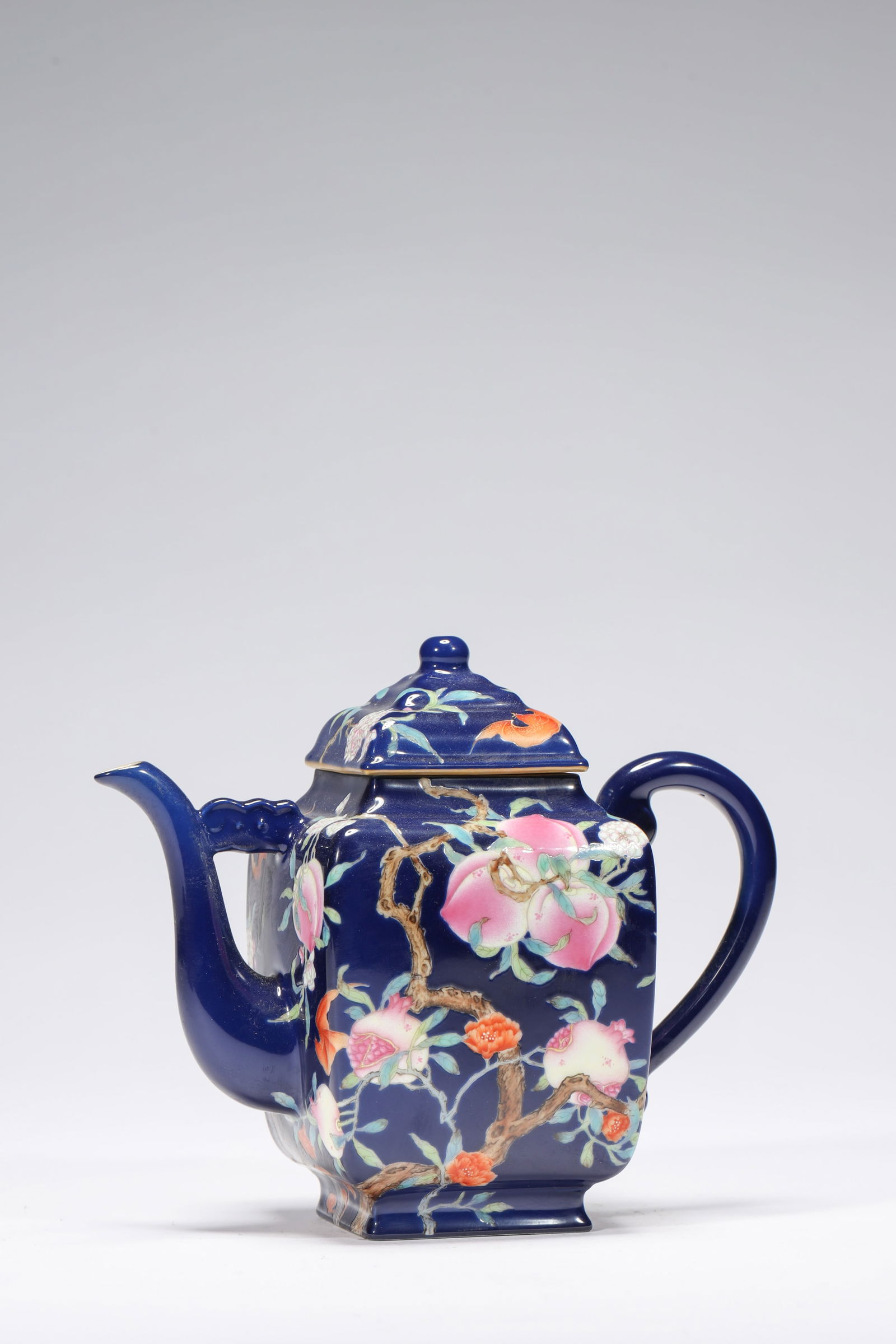 BLUE GROUND PEACH SQUARE KETTLE: Blue ground peach square kettle.Dimensions: Height: 15.7 cm, Width: 19.3 cm.