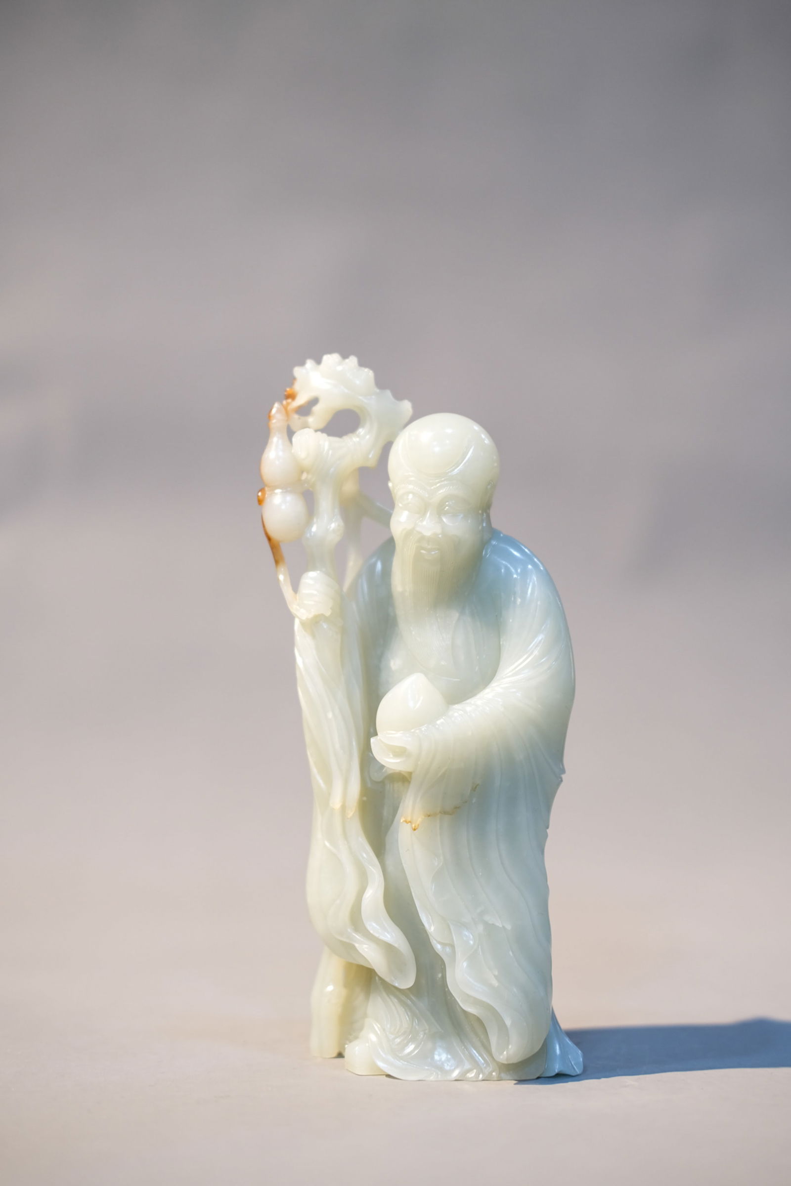 WHITE JADE IMMORTAL STATUE: White jade immortal statue. Dimensions: Height: 17.5 cm, Width: 7.5 cm.